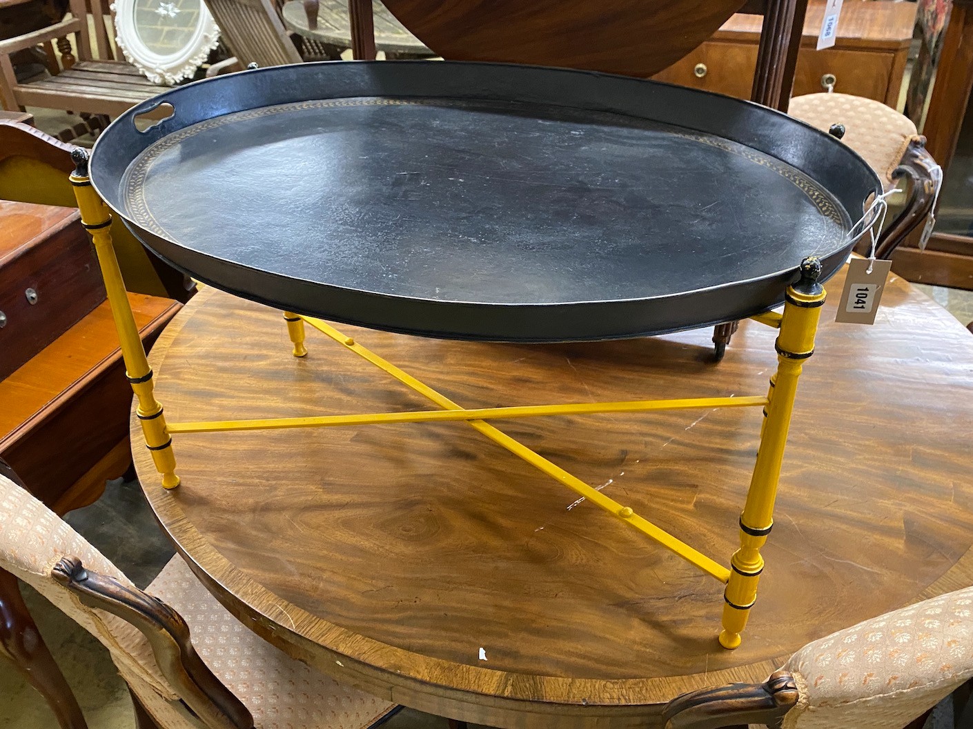 An oval Regency style toleware tray top table on folding stand, width 80cm, depth 61cm, height 43cm